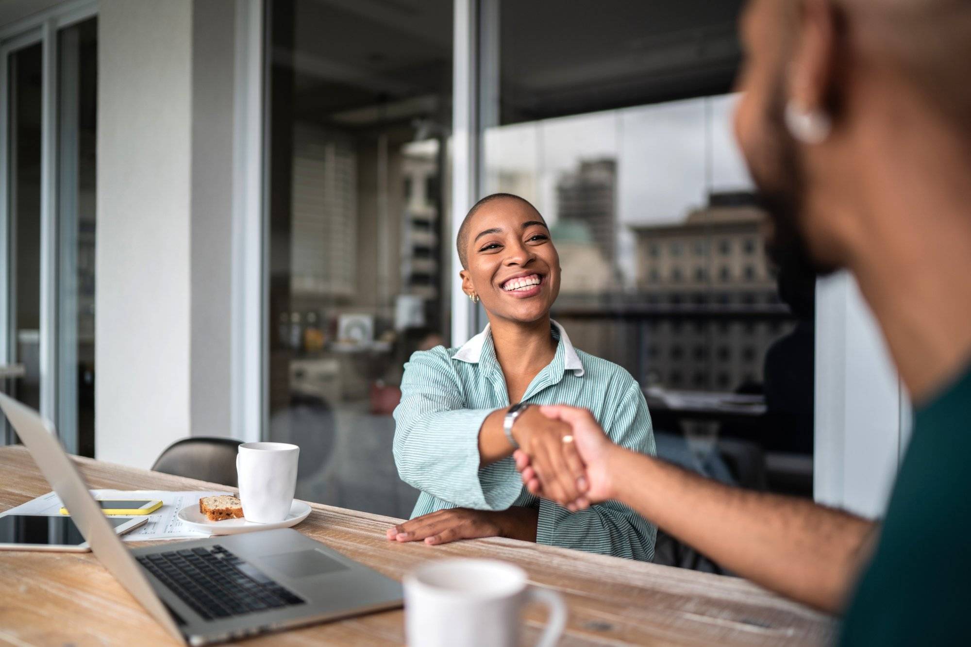Financial advisor shaking hands with customer Financial advisor shaking hands with customer